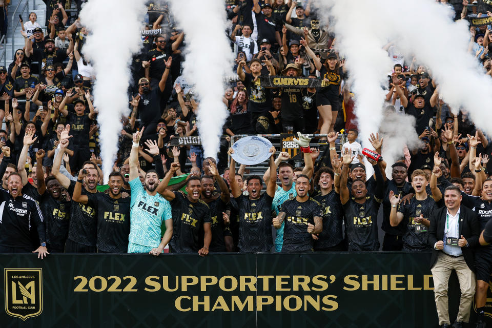 Los Angeles FC players celebrate with the Supporters' Shield trophy after an MLS soccer match against the Nashville SC, Sunday Oct. 9, 2022, in Los Angeles. The Supporters' Shield is awarded to the MLS team with the best regular-season record. (AP Photo/Ringo H.W. Chiu)