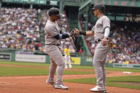 New York Yankees' Gleyber Torres, left, celebrates with Jake Bauers, right, after Torres hit a two-run home run allowing both to score in the first inning of a baseball game against the Boston Red Sox, Sunday, June 18, 2023, in Boston. (AP Photo/Steven Senne)