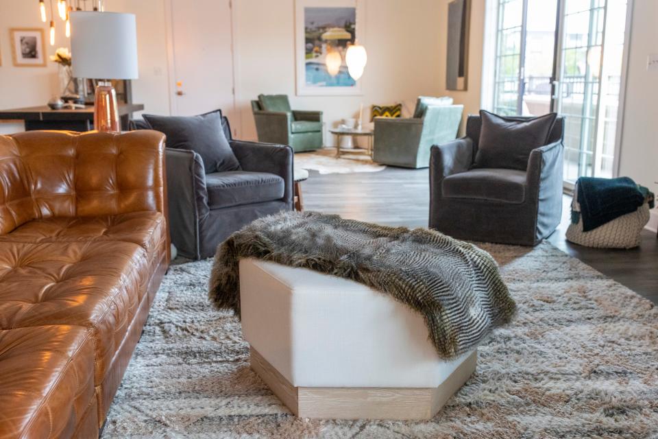 A hexagon shaped foot stool with a fur like throw in the living room space inside Larry and Mary Kay Hesen at The Colston Park Lofts in Jeffersonville, Indiana. Oct. 22, 2021