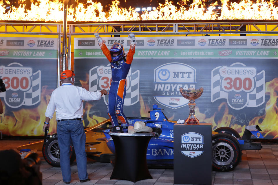 Chip Ganassi, left, looks on as Scott Dixon steps out of his cockpit and onto his car in Victory Lane after winning an IndyCar auto race at Texas Motor Speedway in Fort Worth, Texas, Saturday, June 6, 2020. (AP Photo/Tony Gutierrez)