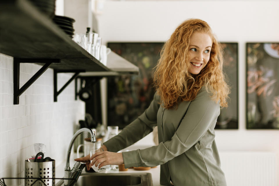 a woman washing dishes 