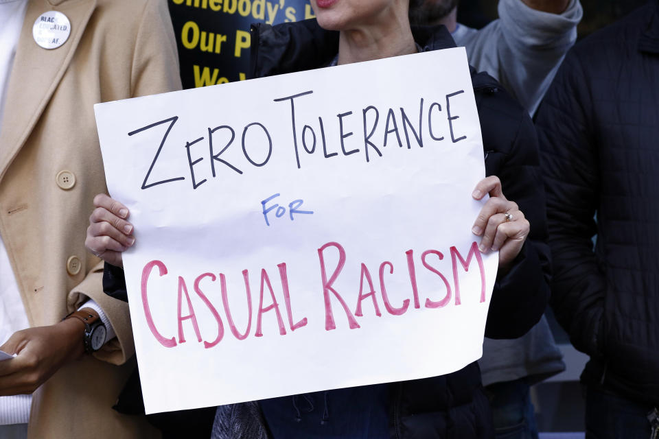 A small crowd of protesters chant and wave signs, including this one, outside the downtown complex that houses the offices of appointed U.S. Sen. Cindy Hyde-Smith, R-Miss., who is locked in a runoff race against Democrat Mike Espy, Friday, Nov. 16, 2018 in Jackson, Miss. Protestors expressed concerns over the senator's comments on "public hanging" and voting rights. Espy and Hyde-Smith are running for the final two years of the six-year term vacated when Republican Thad Cochran retired. (AP Photo/Rogelio V. Solis)