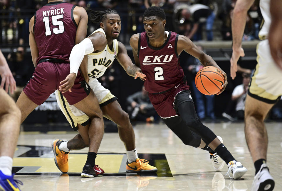 Eastern Kentucky guard Leland Walker (2) drives the ball past Purdue guard Lance Jones during the first half of an NCAA college basketball game Friday, Dec. 29, 2023, in West Lafayette, Ind. (AP Photo/Marc Lebryk)