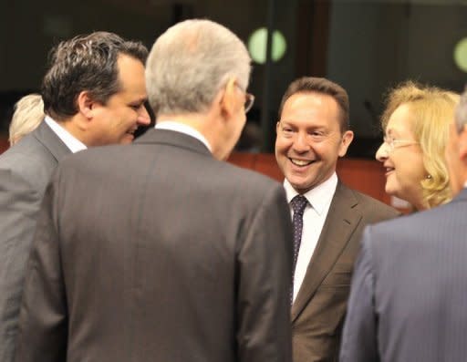 L-R: Dutch Finance Minister Jan Kees de Jager, Italian Prime Minister and Finance Minister Mario Monti, Greek Finance Minister Yiannis Stournaras and Austrian Federal Finance Minister Maria Fekter talk prior to a Eurozone meeting on July 9. European Union finance ministers bought Spain more time to revive its sickly economy on Tuesday, offering 30 billion euros to save the country's banks