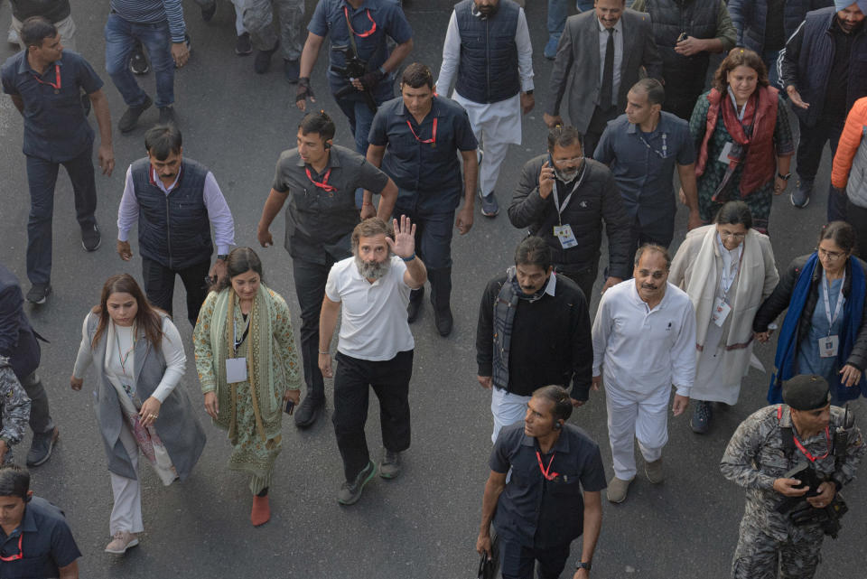 Rahul Gandhi waves as he and his companions walk alongside supporters during the Bharat Jodo Yatra near Aali Village in New Delhi, India on Dec. 24, 2022.<span class="copyright">Ronny Sen for TIME</span>