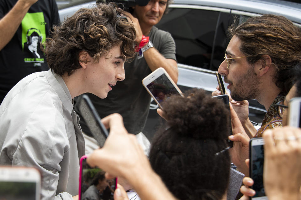 Actor Timothee Chalamet signs autographs upon arrival for the photo call of the film 'The King' at the 76th edition of the Venice Film Festival in Venice, Italy, Monday, Sept. 2, 2019. (Photo by Arthur Mola/Invision/AP)