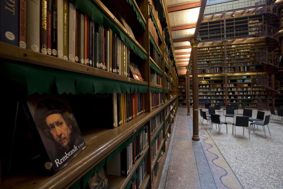 A book of Dutch master Rebrandt is displayed in the library which houses about one fifth of the total collection of books during a press preview of the renovated Rijkmuseum in Amsterdam, Thursday April 4, 2013. The Rijksmusuem, home of Rembrandt's Night Watch and other national treasures, is preparing to reopen its doors on April 13 2013 after a decade-long renovation. (AP Photo/Peter Dejong)