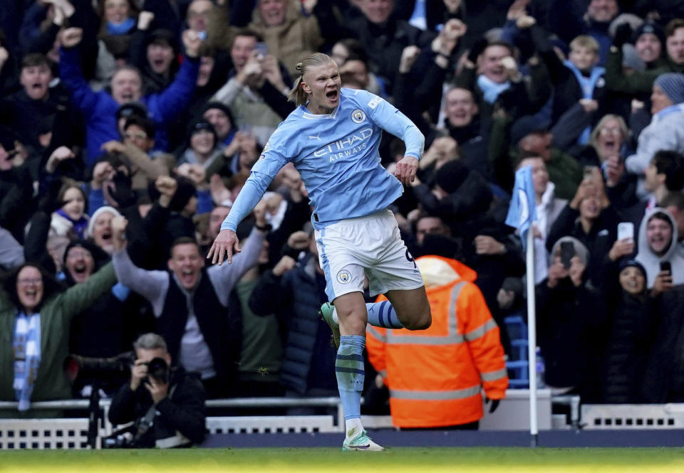 Manchester City's Erling Haaland celebrates scoring the opening goal, during the English Premier League soccer match between Manchester City and Liverpool, at the Etihad Stadium, in Manchester, England, Saturday, Nov. 25, 2023. (Martin Rickett/PA via AP)