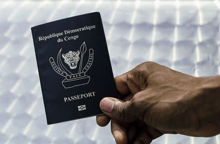 An immigration official displays a Congolese biometric passport in the Democratic Republic of Congo's capital Kinshasa, February 10, 2017. REUTERS/Stringer