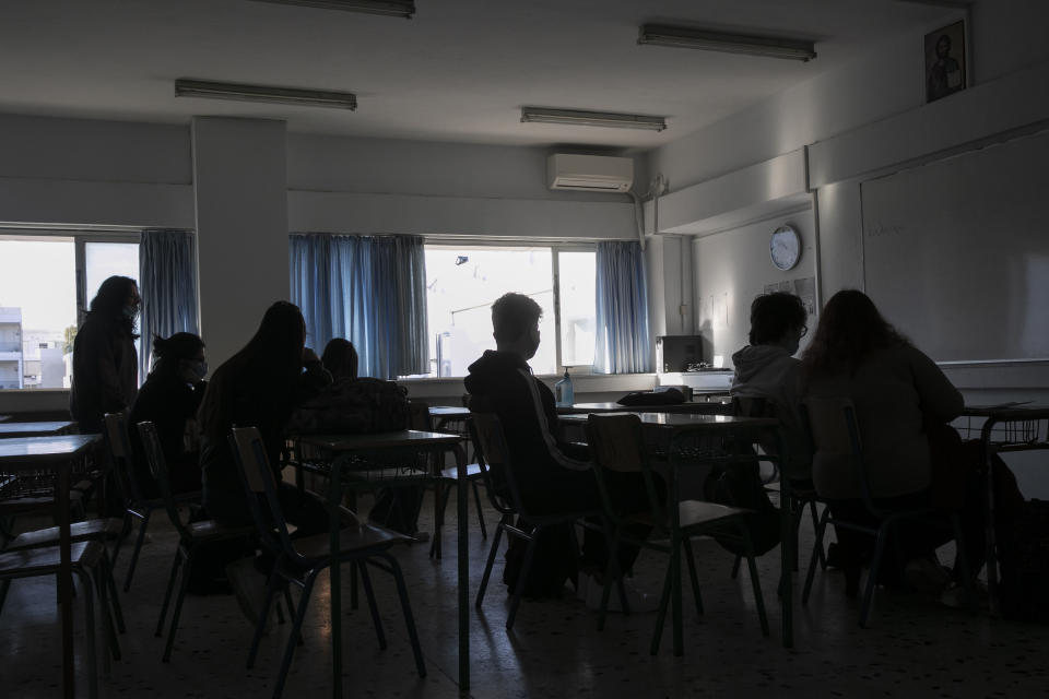 High school students sit inside a classroom at Glyfada suburb, west of Athens, Monday, April 12, 2021. Home tests have been distributed to teachers and students aged 16-18, as authorities reopened high schools for students in the final three grades on Monday. (AP Photo/Yorgos Karahalis)