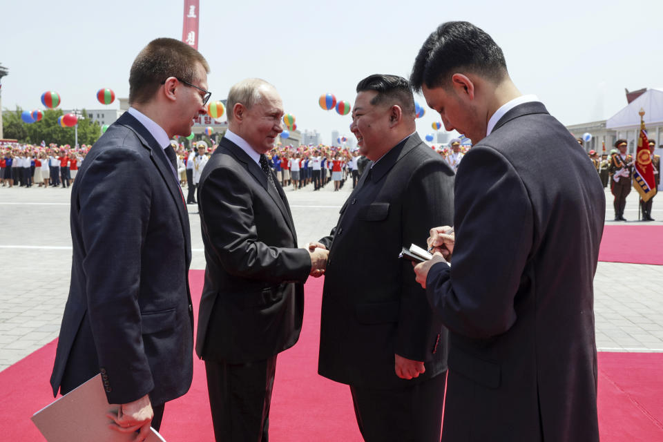 Russian President Vladimir Putin, second left, and North Korea's leader Kim Jong Un, second right, greet each other during the official welcome ceremony in the Kim Il Sung Square in Pyongyang, North Korea, on Wednesday, June 19, 2024. (Gavriil Grigorov, Sputnik, Kremlin Pool Photo via AP)