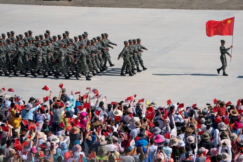 FILE PHOTO: Chinese soldiers of People's Liberation Army (PLA) march during the opening ceremony of four contests hosted by China as part of International Army Games 2019 in Korla, Xinjiang