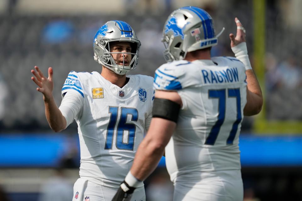 Lions quarterback Jared Goff, left, shakes hands with center Frank Ragnow before the game against the Los Angeles Chargers on Sunday, Nov. 12, 2023, in Inglewood, California.
