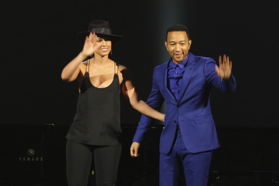 FILE - In this Jan. 27, 2014 file photo, Alicia Keys, left, and John Legend wave after their performance at The Night That Changed America: A Grammy Salute to the Beatles in Los Angeles. Legend latest release "Bigger Love" comes out Friday, June 19. (Photo by Zach Cordner/Invision/AP, File)