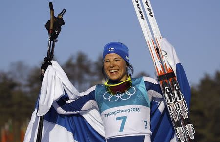 Cross-Country Skiing - Pyeongchang 2018 Winter Olympics - Women's 30km Mass Start Classic - Alpensia Cross-Country Skiing Centre - Pyeongchang, South Korea - February 25, 2018 - Silver medallist Krista Parmakoski of Finland celebrates with her national flag. REUTERS/Carlos Barria