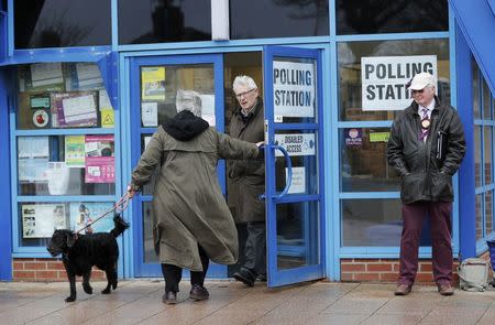 A couple leave a polling station after casting their votes for the Stoke Central by-election in Stoke-on-Trent, Britain, February 23, 2017. REUTERS/Darren Staples