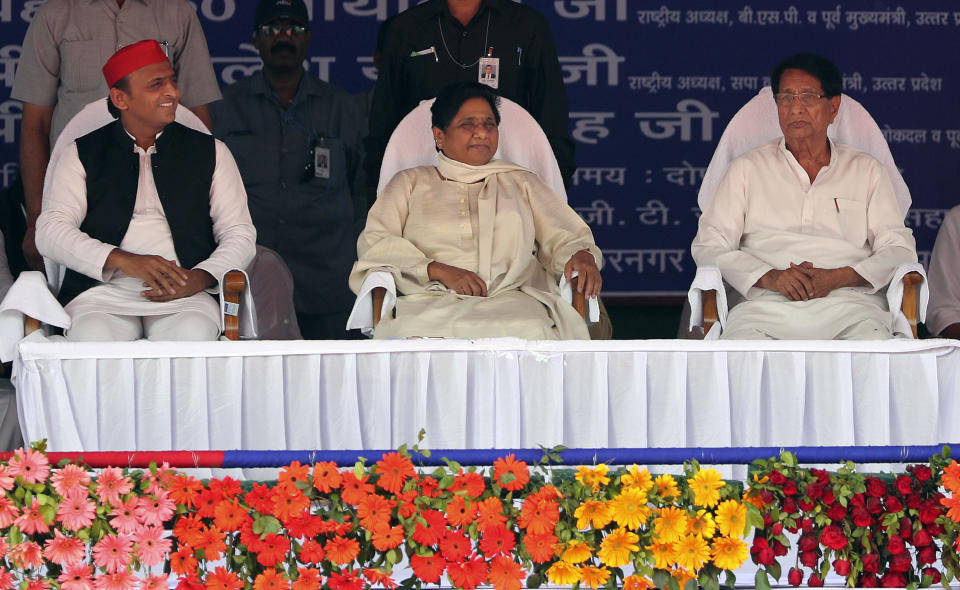 Bahujan Samaj Party (BSP) leader Mayawati, center, Samajwadi Party (SP) leader Akhilesh Yadav, left and Rashtriya Lok Dal (RLD) leader Ajit Singh, right, share the stage during an election rally in Deoband, Uttar Pradesh, India, Sunday, April 7, 2019. Political archrivals in India's most populous state rallied together Sunday, asking voters to support a new alliance created with the express purpose of defeating Prime Minister Narendra Modi's ruling Hindu nationalist Bharatiya Janata Party. (AP Photo/Altaf Qadri)