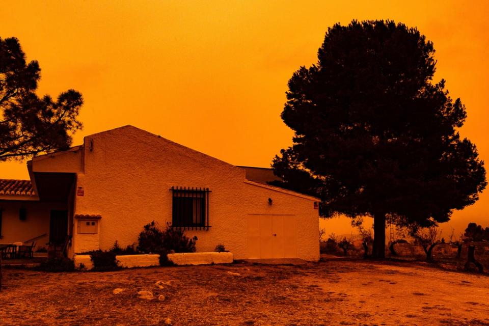 An orange sky is seen over a building in Navares, south-eastern Spain (Javier Carrion/Europa Press via AP) (AP)