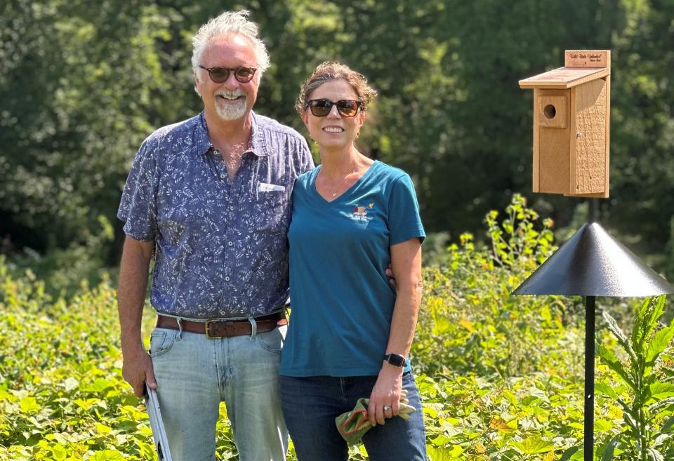 Carey and Lutrelle O'Cain, who are the owners of Wild Birds Unlimited, pose near one of the bluebird houses they installed at the new Brooklyn Creek Bird Sanctuary at Sullivan Park.