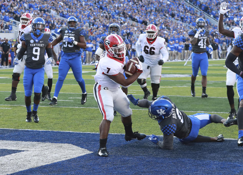 Georgia tailback D'Andre Swift breaks a run for a touchdown against Kentucky during the second quarter in a NCAA college football game Saturday, Nov. 3, 2018, in Lexington, Ky. (Curtis Compton/Atlanta Journal-Constitution via AP)