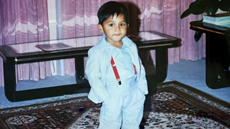 Young Ashish Alfred in a light blue suit 