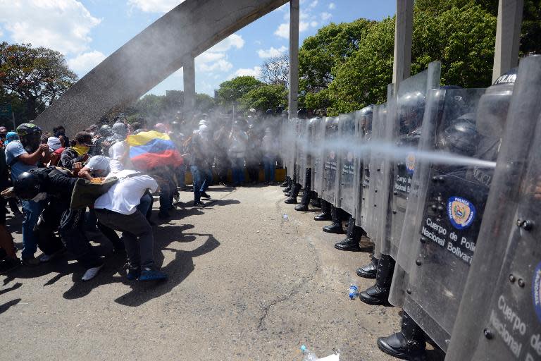 Anti-government activists clash with the National Police during a protest against Venezuelan President Nicolas Maduro, in Caracas, on March 20, 2014