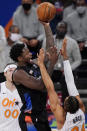 New York Knicks forward Julius Randle (30) goes up for a shot with Orlando Magic center Khem Birch (24) and Magic forward Aaron Gordon (00) defending during the first half of an NBA basketball game, Monday, Jan. 18, 2021, in New York. (AP Photo/Kathy Willens, Pool)