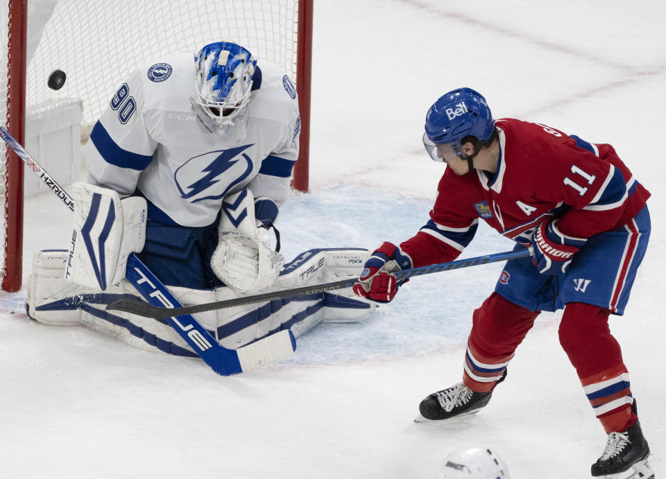 Tampa Bay Lightning goaltender Matt Tomkins (90) makes a save against Montreal Canadiens' Brendan Gallagher (11) during the first period of an NHL hockey game, Tuesday, Nov. 7, 2023 in Montreal. (Christinne Muschi/The Canadian Press)