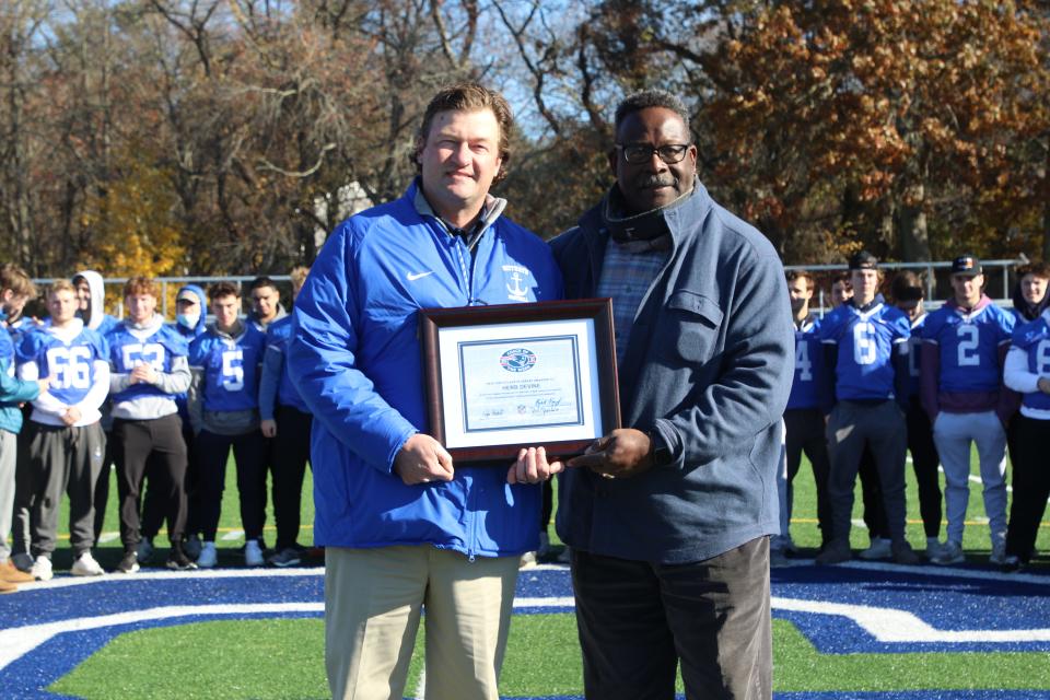 Scituate High football coach Herb Devine, left, poses with New England Patriots Hall of Fame linebacker Andre Tippett at the school on Tuesday, Nov. 16, 2021. Devine was selected as the New England Patriots High School Coach of the Week for the Sailors' 21-14 win over Ashland in the Div. 4 state quarterfinals.