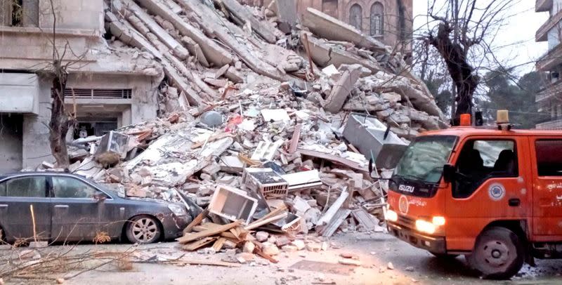 A civil defence vehicle is seen near rubble, following an earthquake, in Aleppo