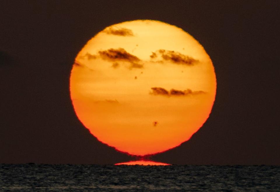 The sun rises over the horizon at Coral Cove Park in Tequesta, Florida on July 10, 2023.