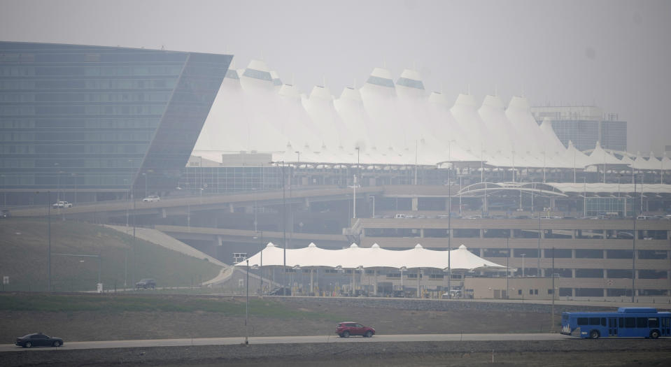 Heavy smokeshrouds the terminal at Denver International Airport Friday, May 19, 2023, in Denver. Smoke from numerous wildfires burning in the Canadian province of Alberta has rolled into Colorado, triggering air quality health advisory alerts across the state and giving Denver the ranking of third worst air quality of any major cities across the globe for the day. (AP Photo/David Zalubowski)