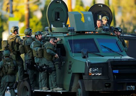 Police officers conduct a manhunt after a mass shooting in San Bernardino, California December 2, 2015. REUTERS/Mike Blake