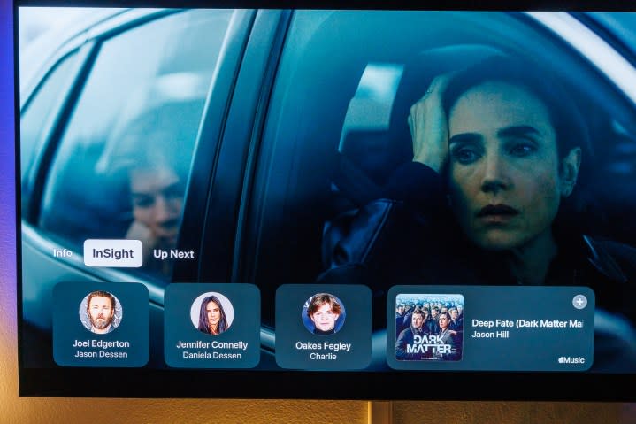Apple TV's Insight feature showing character and music information on screen.