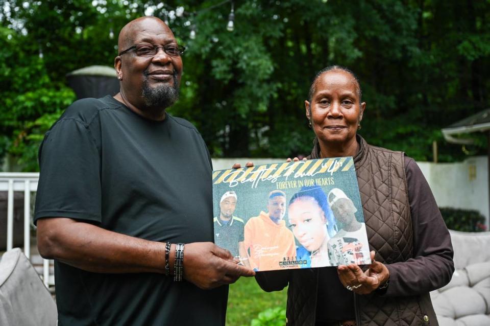 Charles Billings, left, and his wife, Bridgette, hold a collage that includes their late son, Jamaa Cassell (far left), at their home on Thursday, June 22, 2023 in Charlotte, NC. Three years ago Cassell was one of four people killed at a Juneteenth celebration on Beatties Ford Road. To this day, the case remains open and no suspects have been charged.