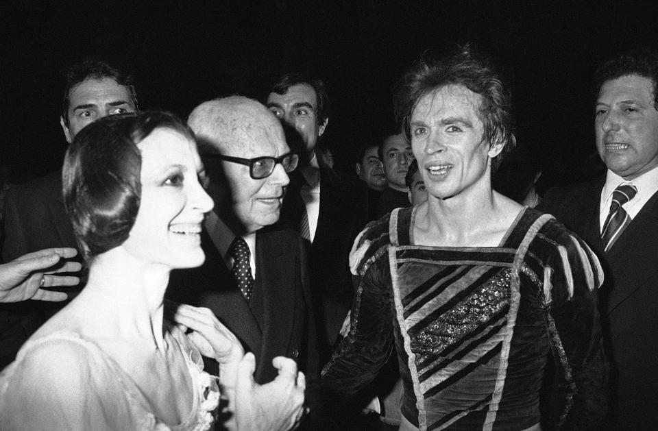 Italian ballet star Carla Fracci and Rudolf Nureyev are congratulated by Italian President Sandro Pertini after their performance in "Giselle" at the Rome Opera House, Feb. 7, 1980. Carla Fracci, an Italian cultural icon and former La Scala prima ballerina who formed a memorable partnership with Rudolf Nureyev, has died at her home in Milan. She was 84. The La Scala theater announced her death Thursday with “great sadness,” without giving a cause. (AP Photo/Gianni Foggia)