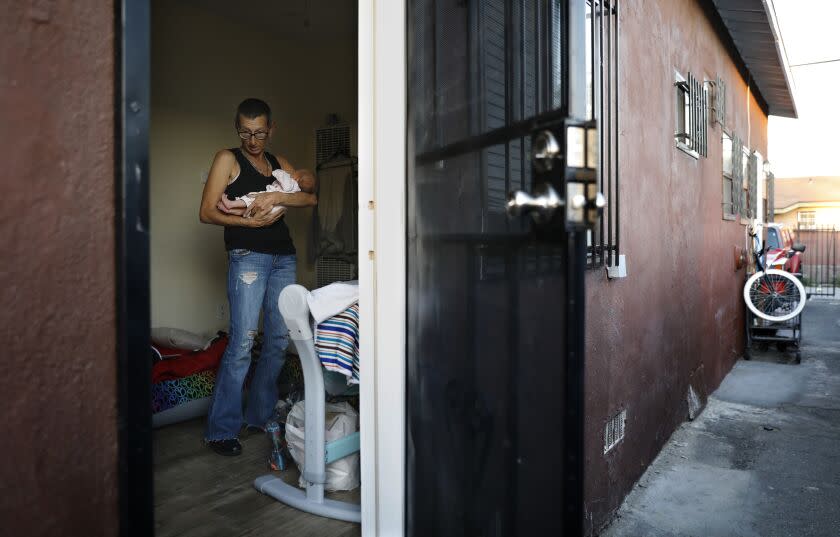 **DO NOT PUBLISH. PHOTOS FOR MCKENZIE PROJECT ONLY**Cat Trahan holds her four-day-old granddaughter Ann at Mckenzie's friend Christina Bojorquez's studio apartment in South Los Angeles. Mckenzie decided to stay at Bojorquez's place after leaving the hospital following the birth of Ann in order to have her mom help her with the baby. Her own apartment does not allow visitors, a rule of the program providing the housing. (Christina House / Los Angeles Times)