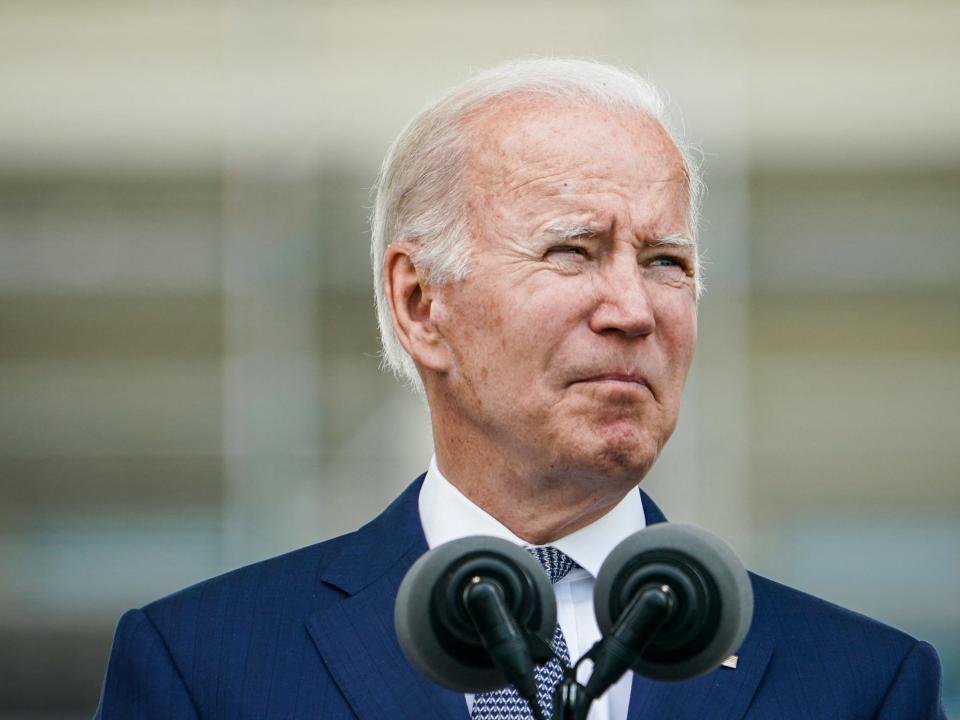 Joe Biden looks off to his left while squinting during a speech.