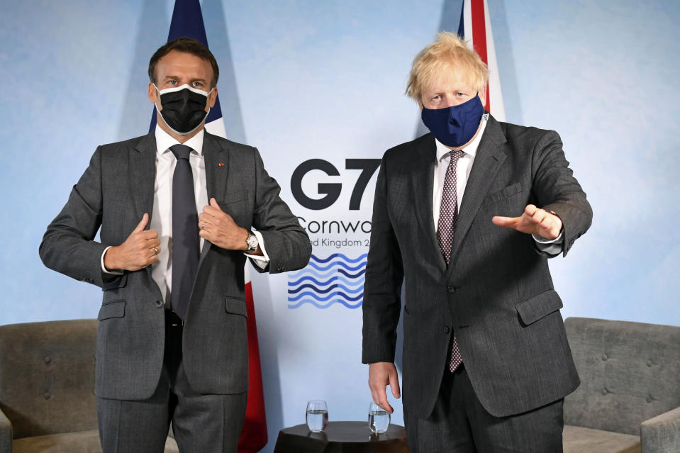 Britain's Prime Minister Boris Johnson, right, and French President Emmanuel Macron ahead of a bilateral meeting during the G7 summit in Cornwall, England, Saturday June 12, 2021. (Stefan Rousseau/Pool via AP)