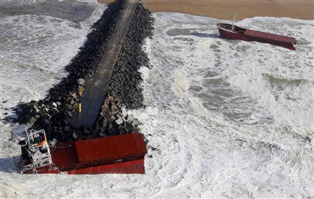 An aerial view show waves which break against a Spanish cargo ship carrying fertiliser, broken in two, off the beach in Anglet on the Atlantic Coast of France, February 5, 2014. REUTERS/Regis Duvignau