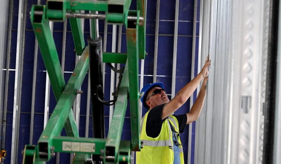 Construction workers paused as House Speaker Mike Johnson, R-LA, toured the construction site for the $100 million ground-level passenger terminal at Sarasota Bradenton International Airport.
