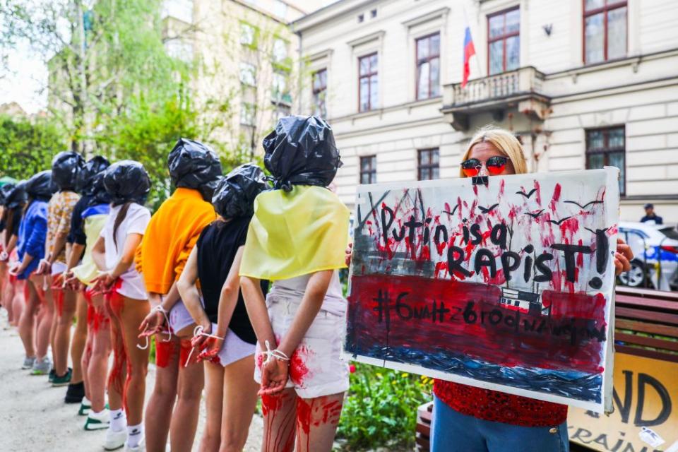 Women attend a protest called 'Rape Is a War Crime' in front of the Consulate General of Russia in Krakow, Poland, on May 8, 2022. A day before "Victory Day" celebrated by Russians to commemorate the victory of World War II, protesters representing rape victims stood in silence to demonstrate against violence and brutal rapes of Ukrainan women and children by Russians soldiers during the ongoing invasion on Ukraine. (Photo by Beata Zawrzel/NurPhoto via Getty Images)