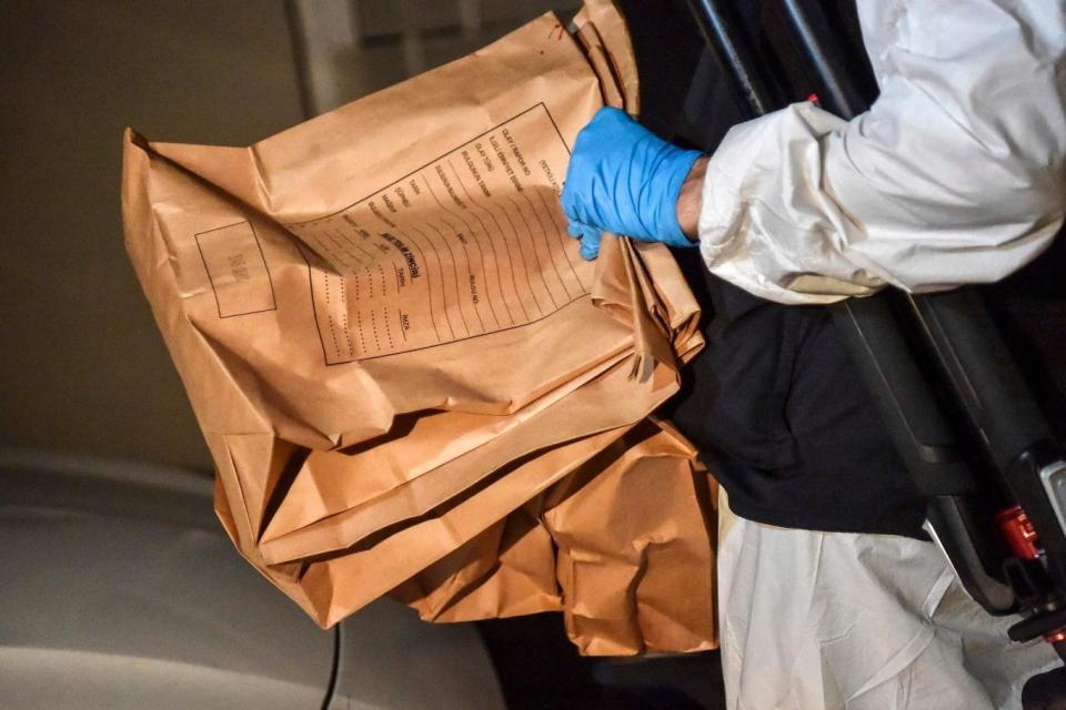A Turkish forensic police officer carries evidence packs while he leaves the Saudi consulate (AFP/Getty Images)