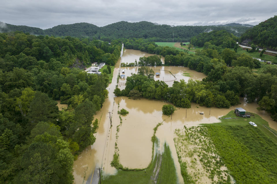 Buildings and roads are flooded near Wolverine, Ky., Thursday, July 28, 2022. Heavy rains have caused flash flooding and mudslides as storms pound parts of central Appalachia. Kentucky Gov. Andy Beshear says it's some of the worst flooding in state history. (Ryan C. Hermens/Lexington Herald-Leader via AP)