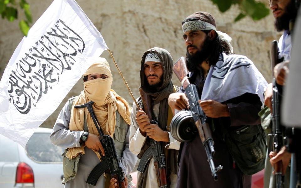 Taliban walk as they celebrate ceasefire in Ghanikhel district of Nangarhar province - REUTERS