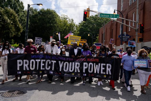 Atlantans demonstrate in favor of federal voting rights legislation on Aug. 28, the 58th anniversary of the March on Washington, which paved the way for the passage of the Civil Rights Act of 1964 and the Voting Rights Act of 1965. (Photo: Brynn Anderson/Associated Press)