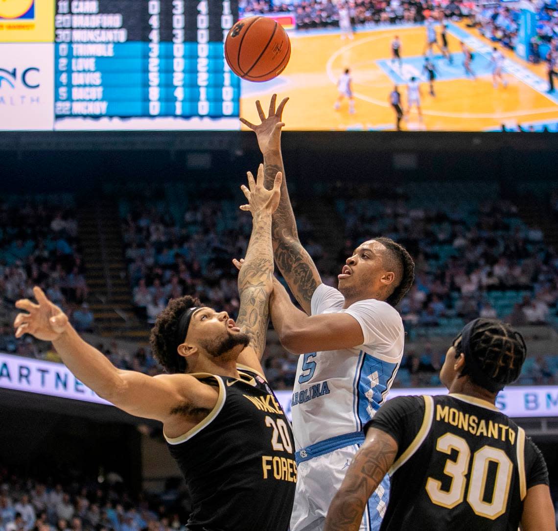 North Carolina’s Armando Bacot (5) puts up a shot against Wake Forest’s Davion Bradford (20) and Damari Monsanto (30) in the first half on Wednesday, January 4, 2023 at the Smith Center in Chapel Hill, N.C.