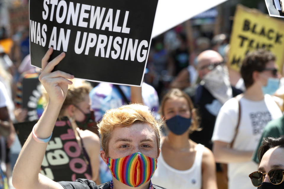 FILE - A person holds up a sign referencing the Stonewall Inn, during a queer liberation march for Black Lives Matter and against police brutality, Sunday, June 28, 2020, in New York. Parades celebrating LGBTQ pride kick off in some of America's biggest cities Sunday amid new fears about the potential erosion of freedoms won through decades of activism. The annual marches in New York, San Francisco, Chicago and elsewhere take place just two days after one conservative justice on the Supreme Court signaled, in a ruling on abortion, that the court should reconsider the right to same-sex marriage recognized in 2015. (AP Photo/Kathy Willens, File)