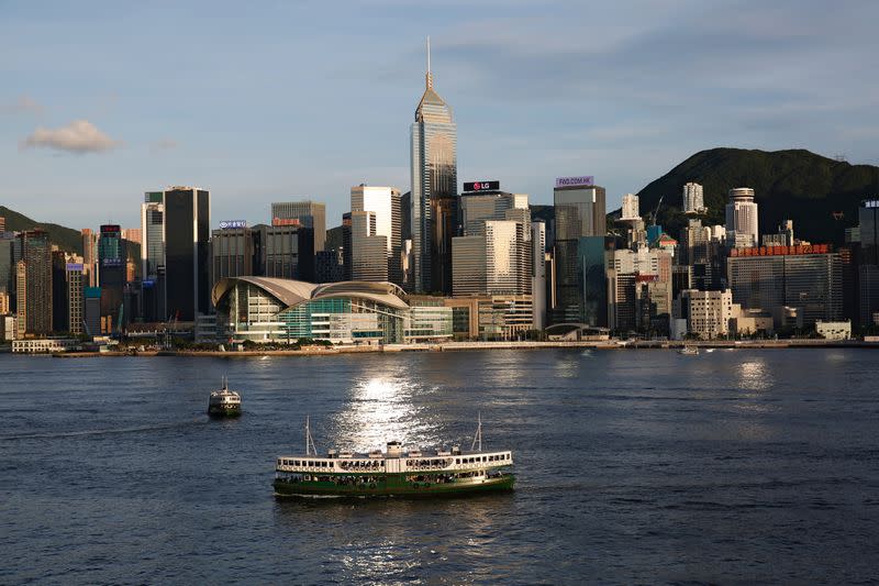 A Star Ferry boat crosses Victoria Harbour in front of a skyline of buildings during a meeting on national security legislation, in Hong Kong
