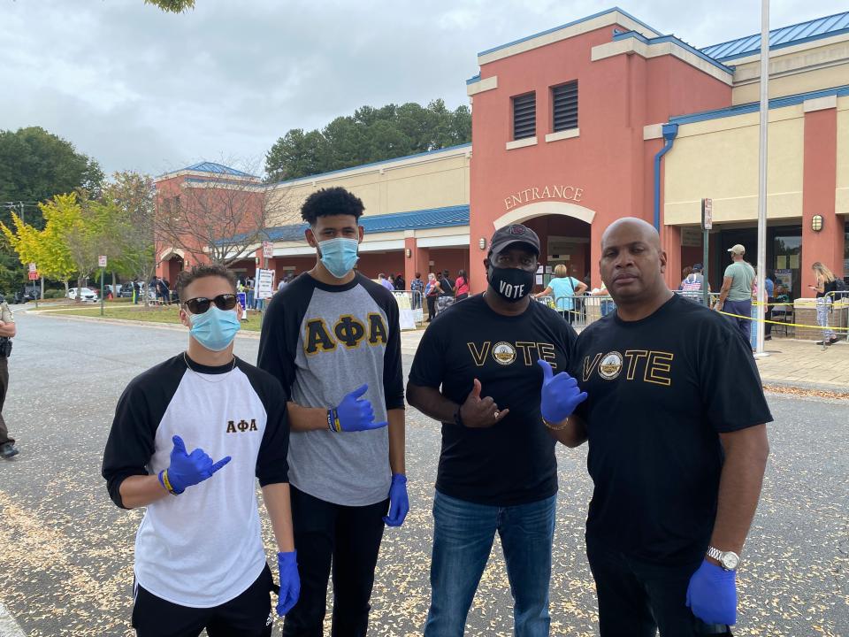 Anthony Lagroon (right) and fellow members of the Cobb Alpha fraternity, on hand to help voters in Marietta, Georgia.Richard Hall / The Independent